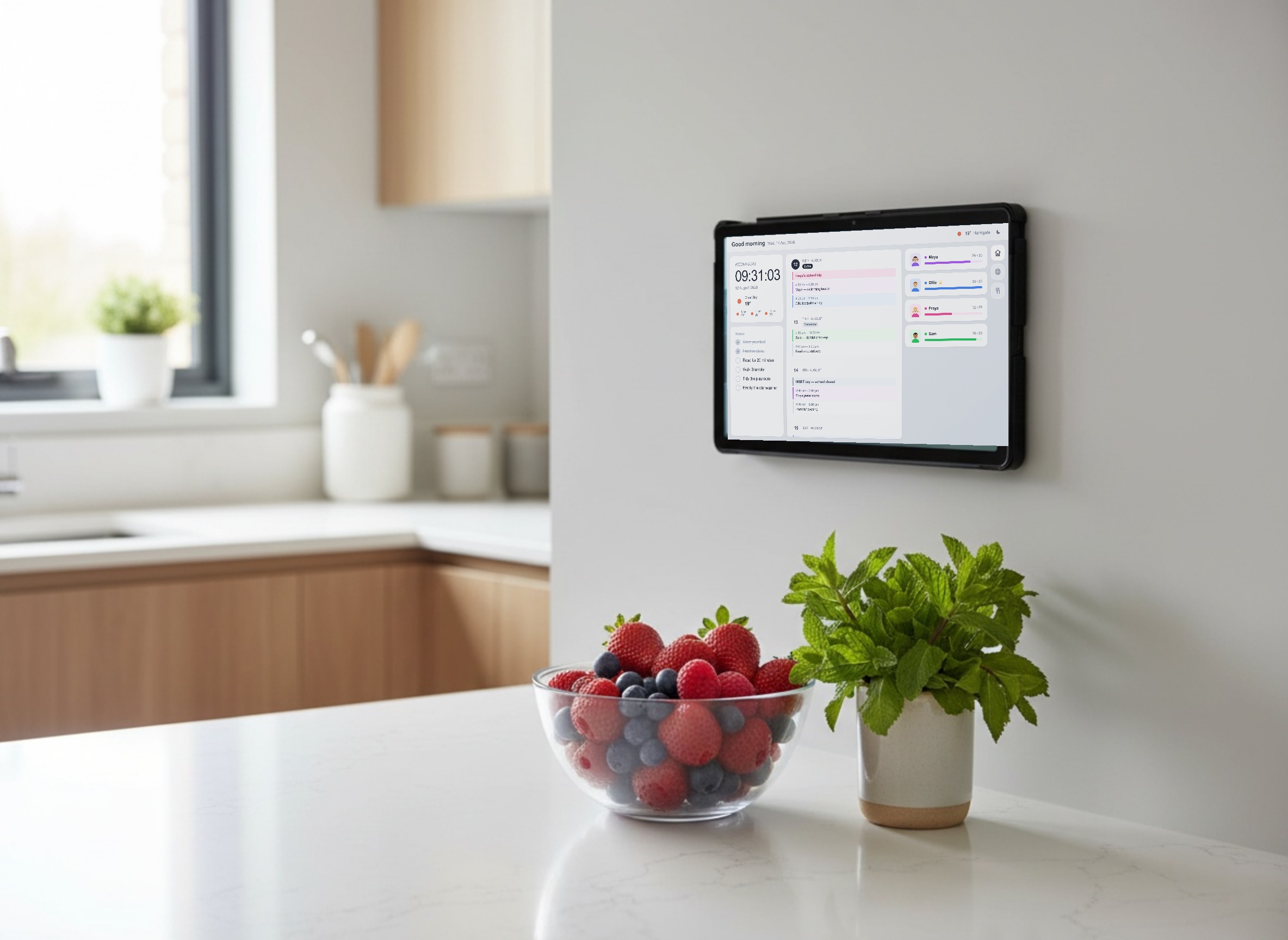 A tablet mounted on a kitchen wall showing the Family Board home screen with the clock, weather, today's list, calendar events and family progress